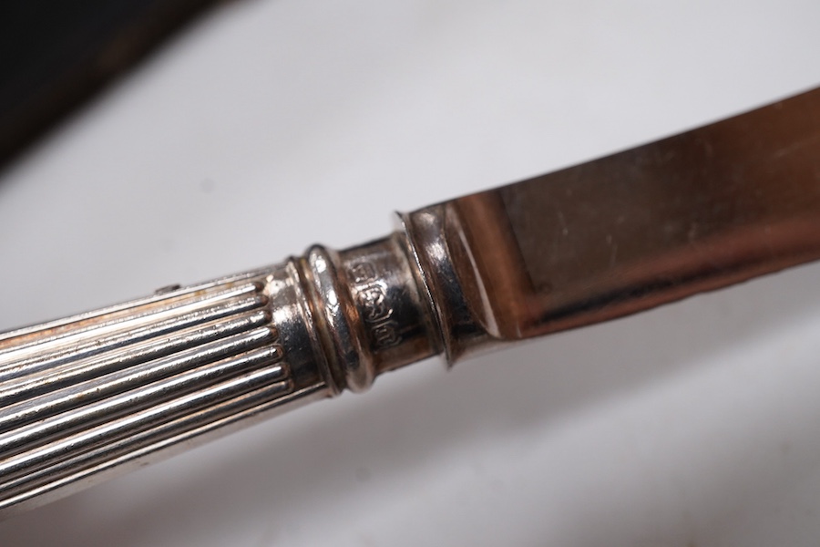 A cased set of six pairs of silver pistol handled dessert eaters, by James Dixon & Sons Ltd, Sheffield, 1905, knife 16.6cm.